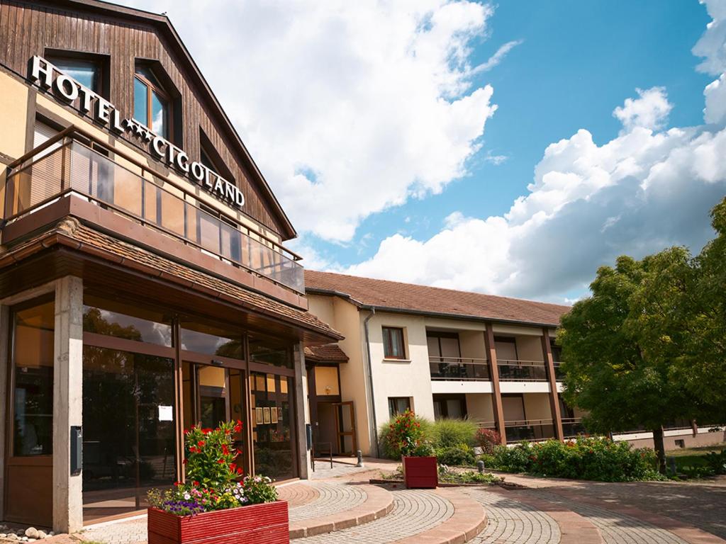 a building with a sign on the side of it at Hotel Cigoland in Kintzheim