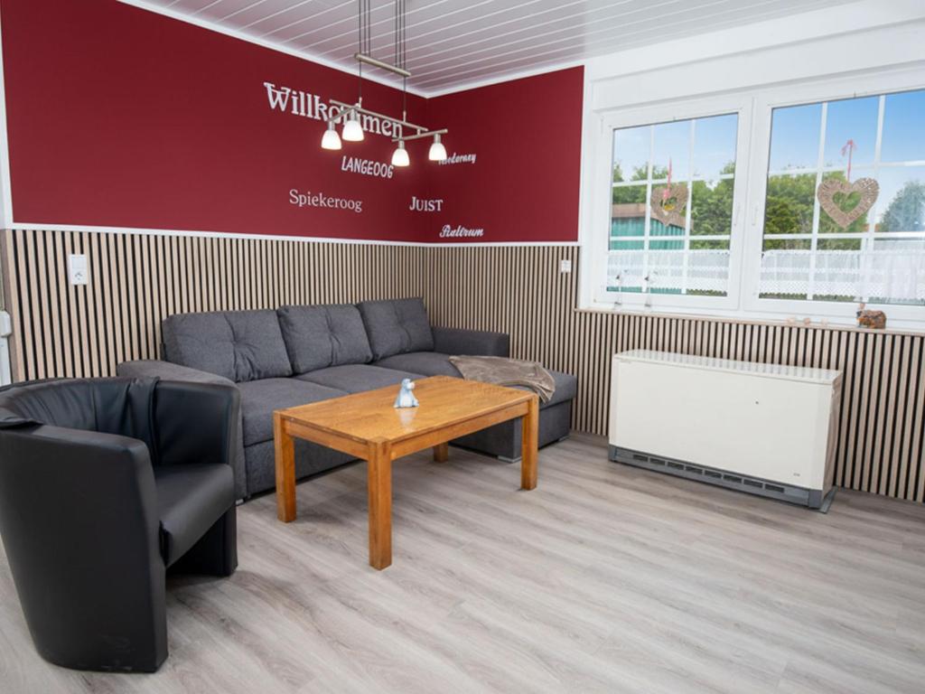 a living room with a couch and a coffee table at Holiday Home Gila by Interhome in Dornumersiel