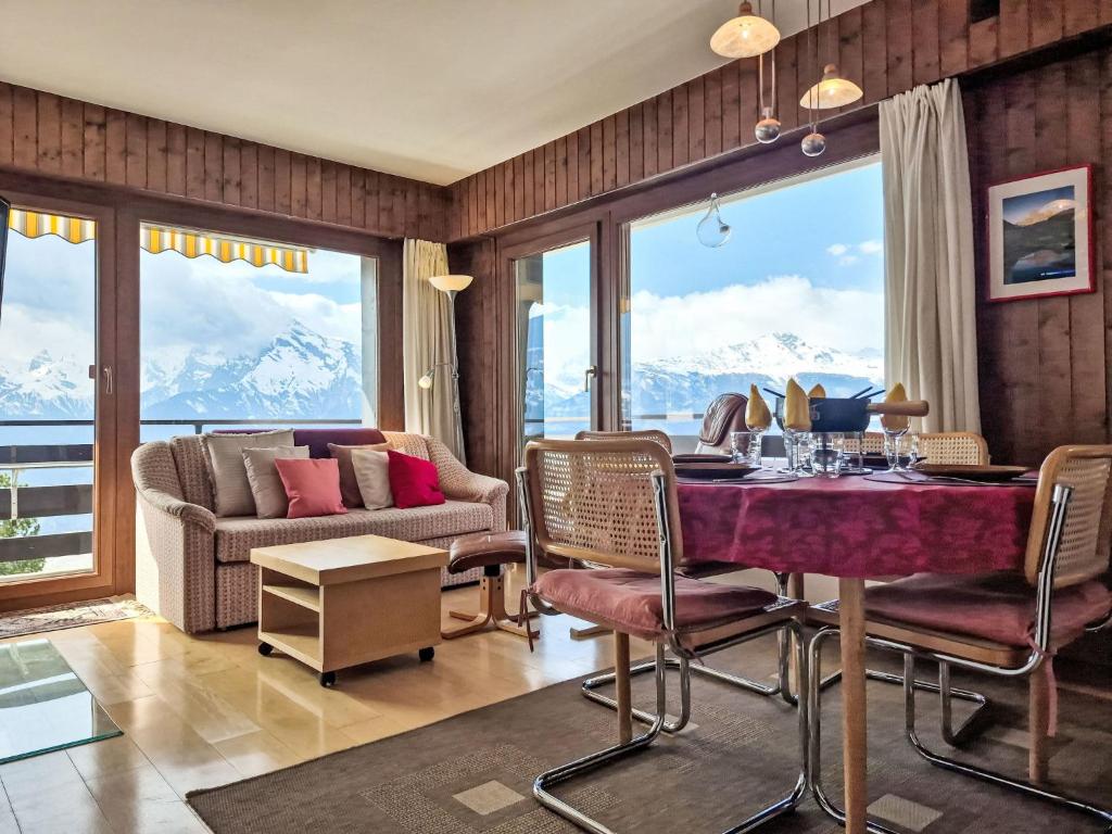 a living room with a table and chairs and a couch at Apartment App- 20A Ramuge by Interhome in Veysonnaz