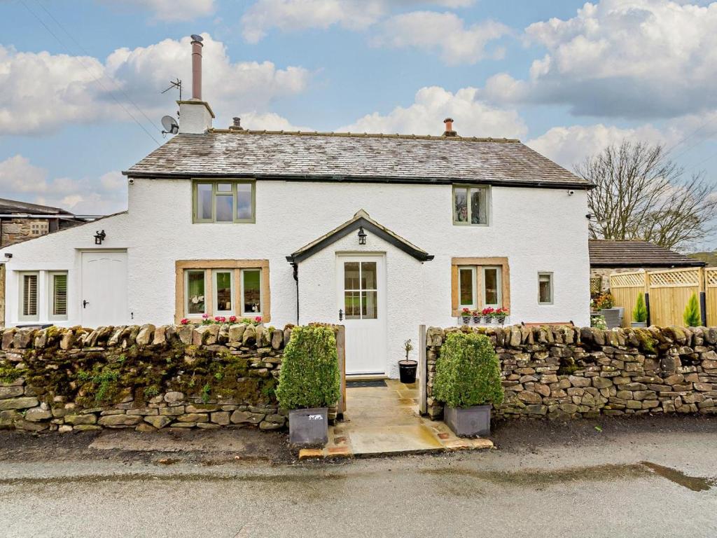a white house with a stone wall at 2 Bed in Skipton oc-91296 in Bramley