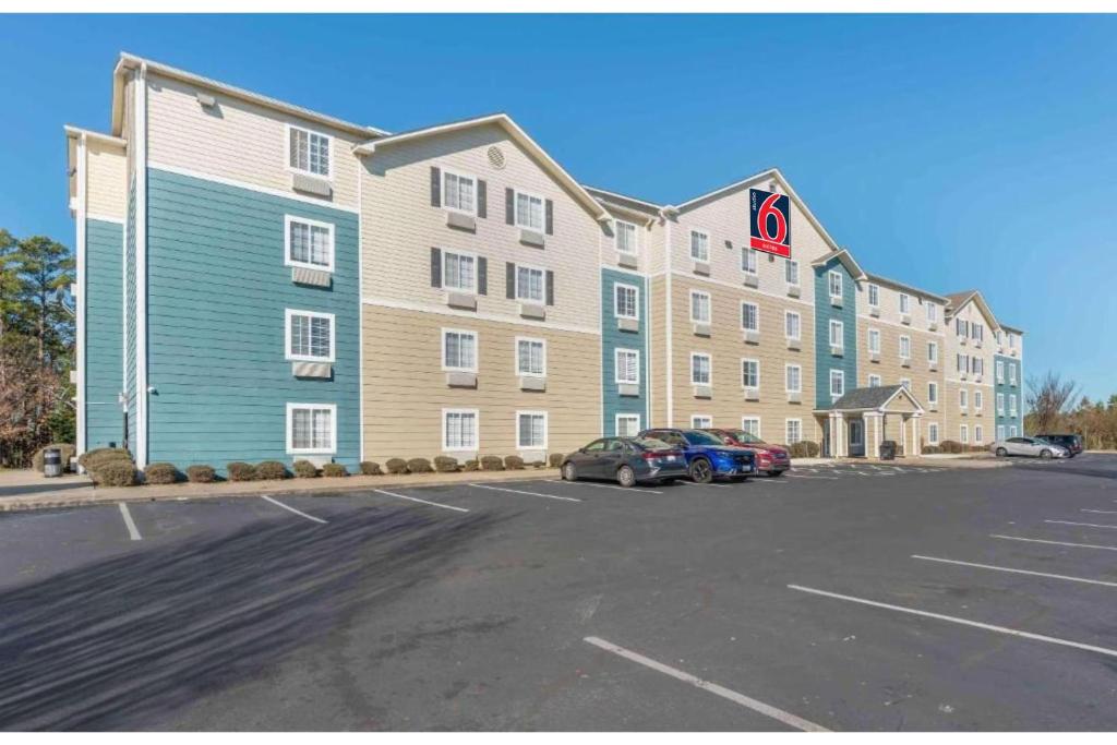 a large building with cars parked in a parking lot at Studio 6 Extended Stay Little Rock Southwest AR in Little Rock
