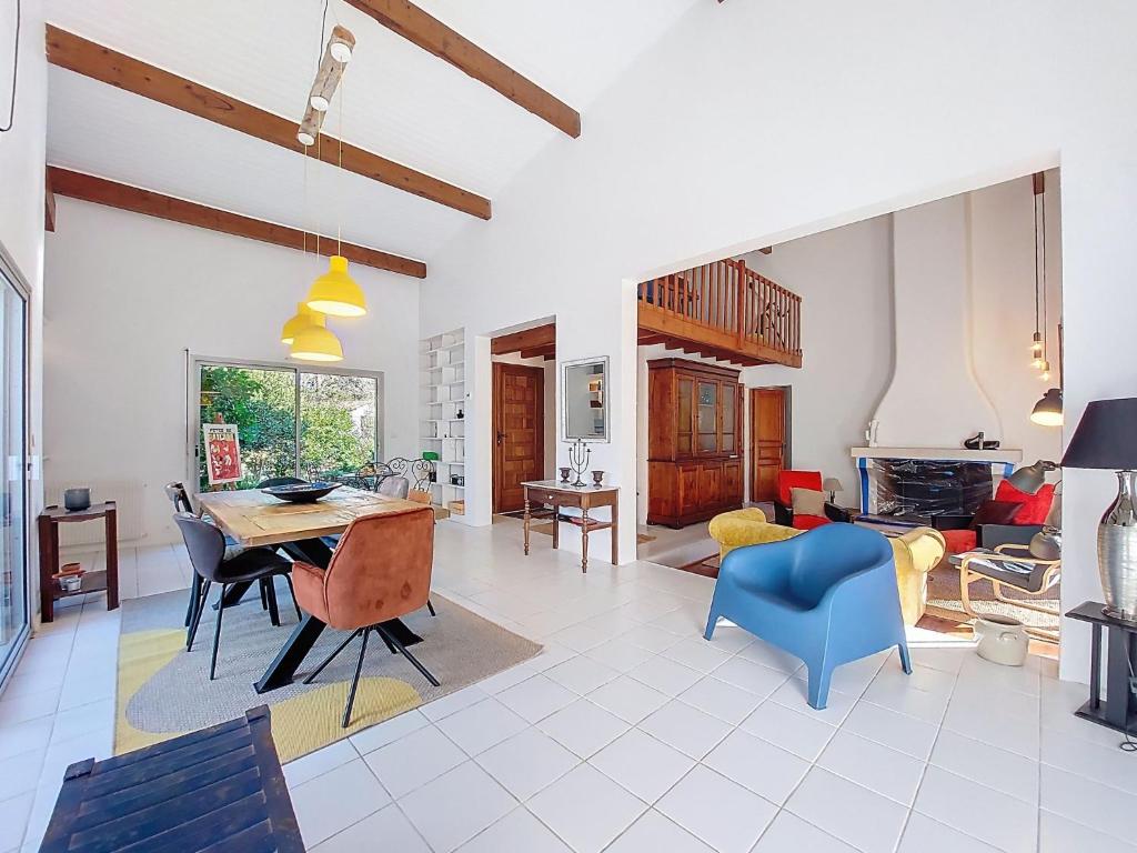 a living room with a table and chairs at Holiday Home Bernadon by Interhome in Labenne