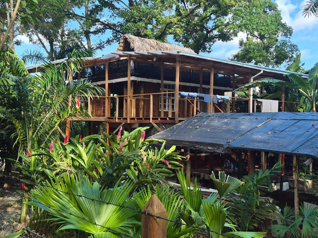 a wooden house with a black roof at Cabaña LA IGUANA in Capurganá