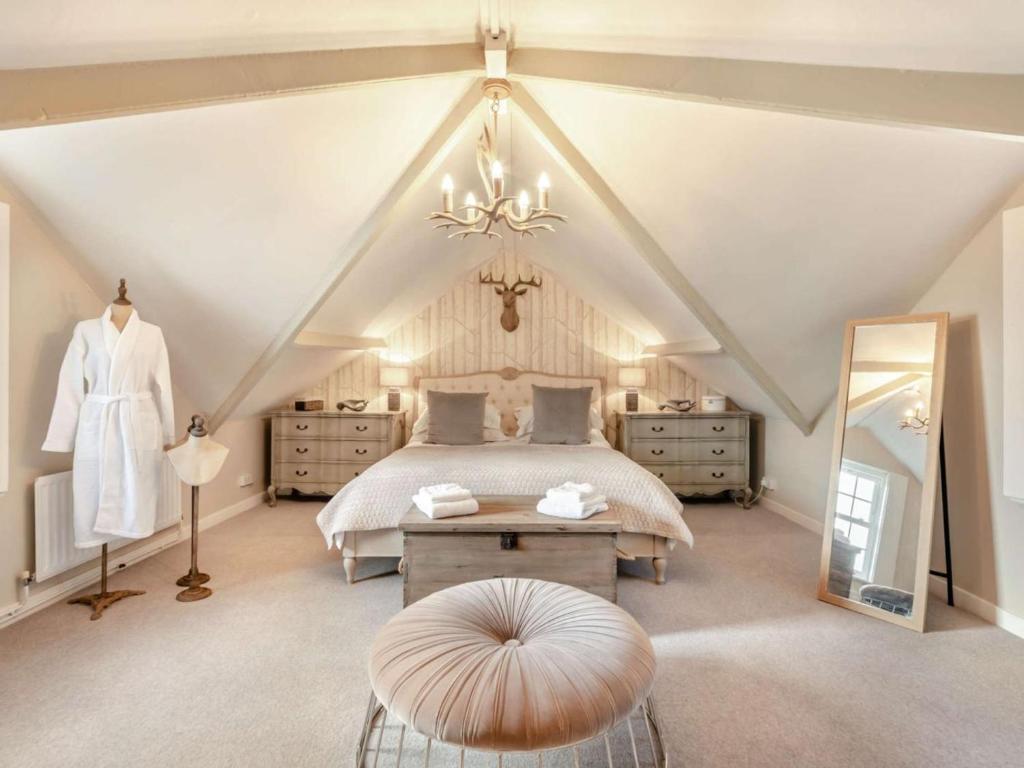 a attic bedroom with a bed and a mirror at 2 Bed in Consett oc-90576 in Whittonstall