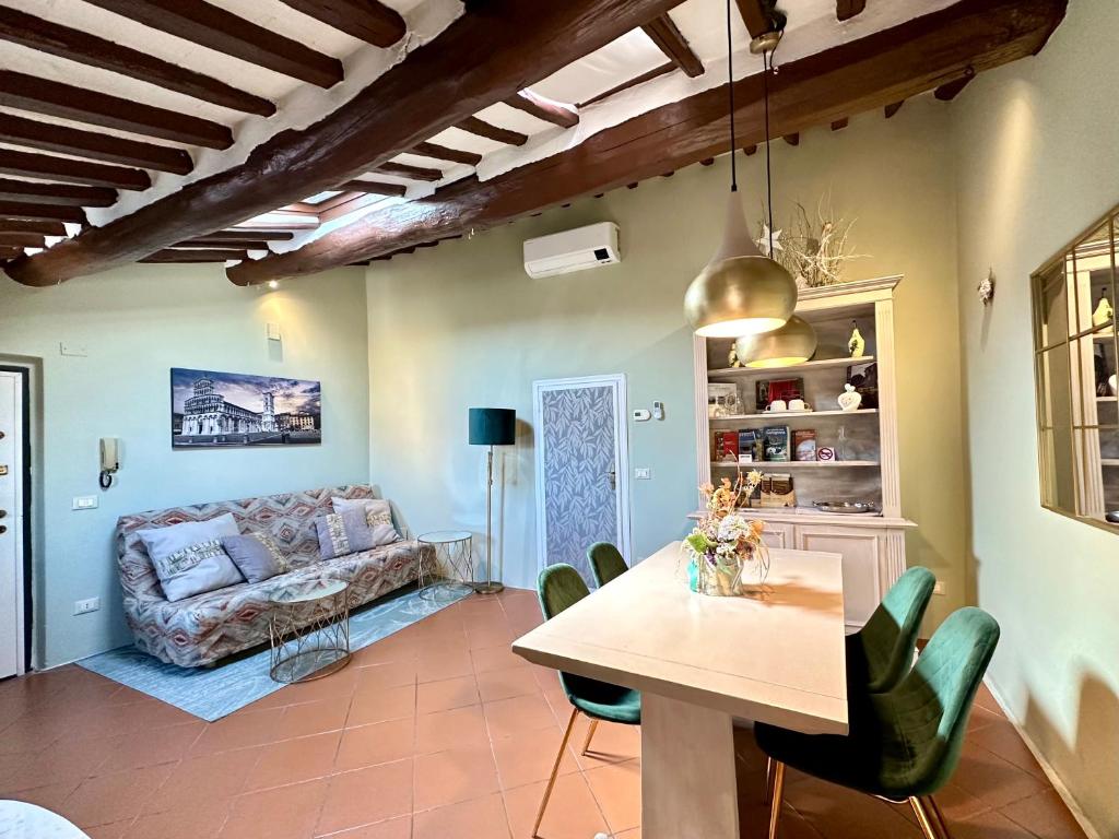 a living room with a table and a couch at Galli Tassi Suite in Lucca