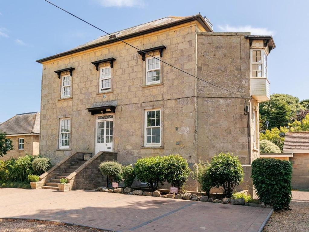 an old stone house with a staircase in front of it at 3 Bed in Ventnor oc-89972 in Niton