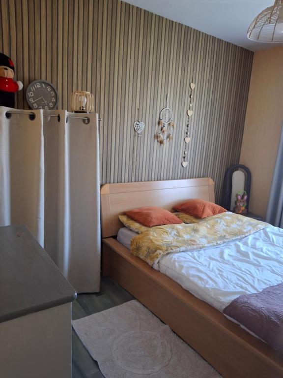 a bedroom with a bed and two refrigerators at Golf Home in Écommoy