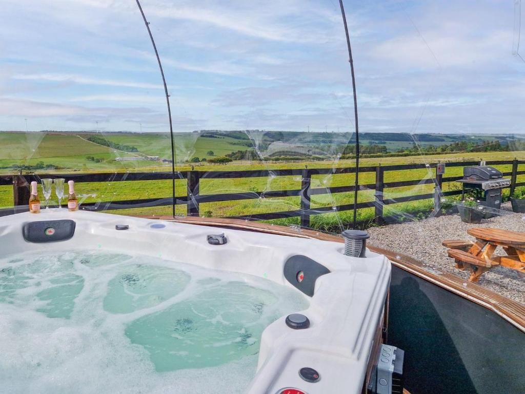 a jacuzzi tub with a view of the countryside at 3 Bed in Bishop Auckland oc-94320 in Wolsingham