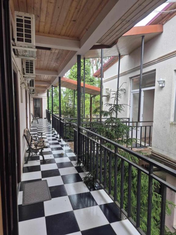 a balcony with a black and white checkered floor at Hotel Roba in Ureki