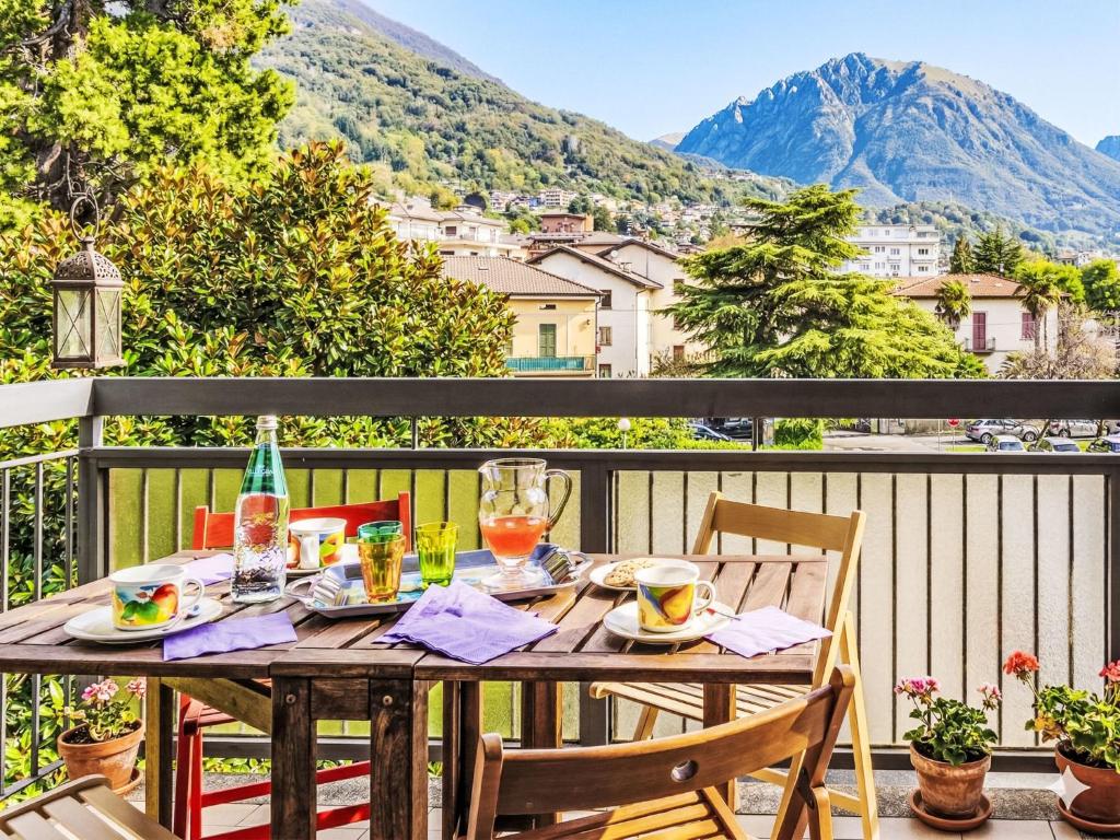 a table on a balcony with a view of a mountain at Apartment Francesca by Interhome in Porlezza