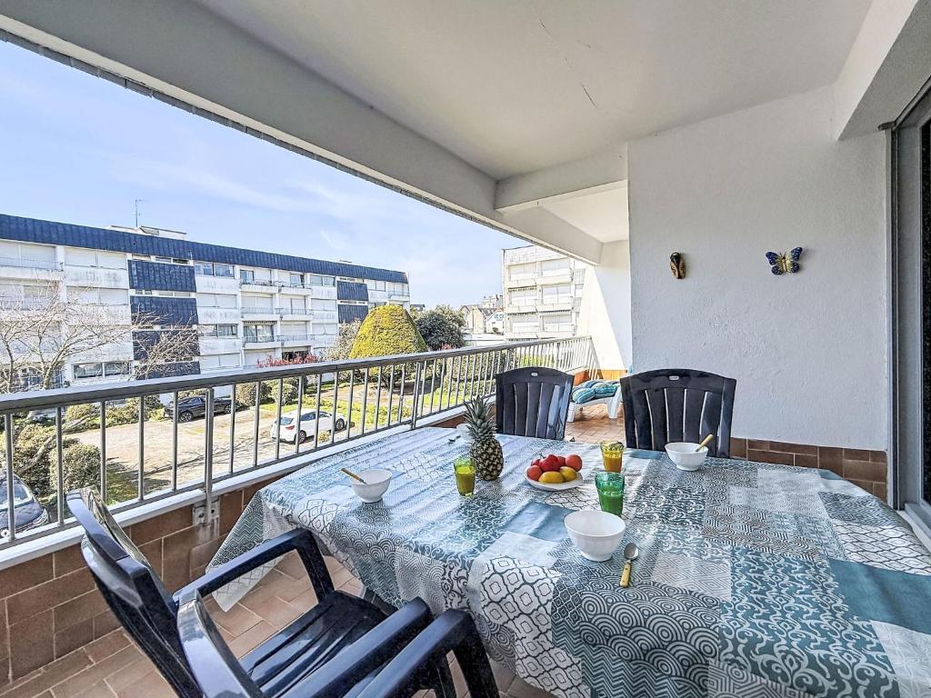 a table and chairs on a balcony with a view at Apartment Kérabus-3 by Interhome in Quiberon