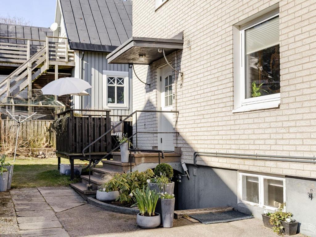 a house with a porch with an umbrella at Apartment Vårhemsplatsen by Interhome in Halmstad