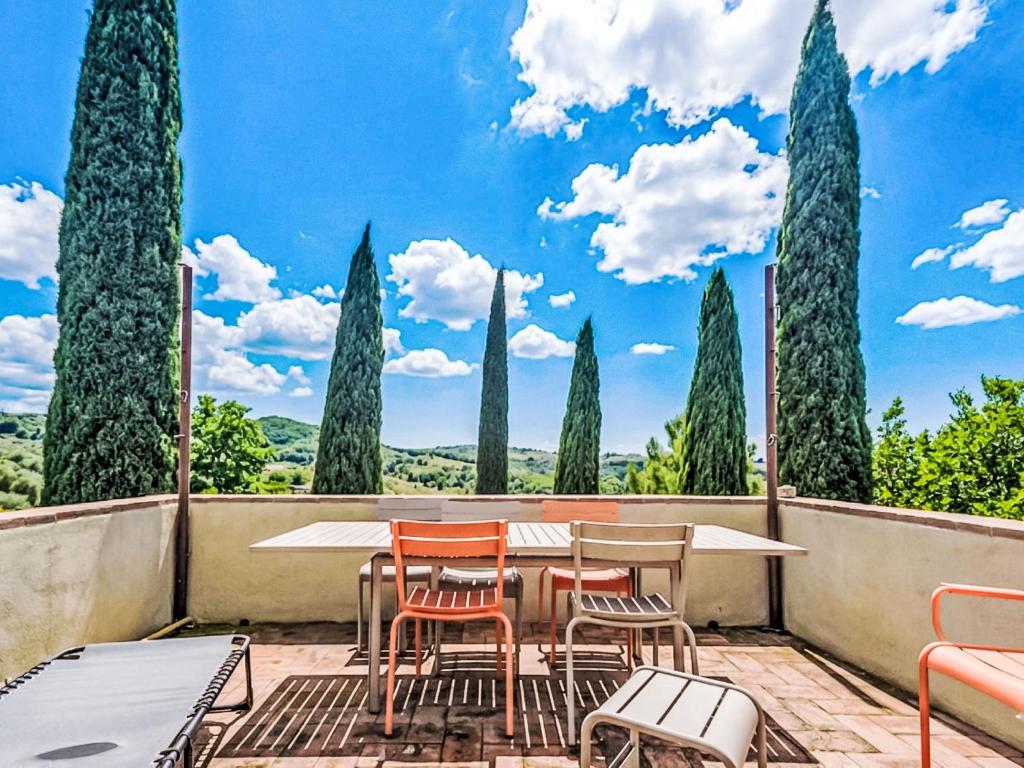 a patio with a table and chairs and trees at Holiday Home Nobile by Interhome in Polveraia
