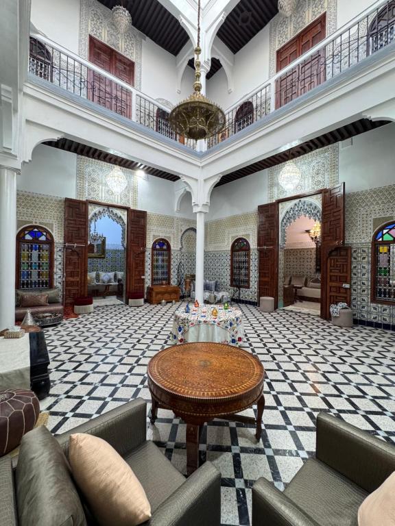 a large lobby with a table in the middle at Riad El abrar in Salé