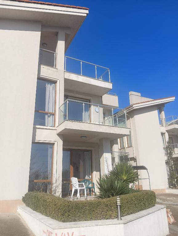 a large white building with a table in front of it at Sun Village House 14 in Byala