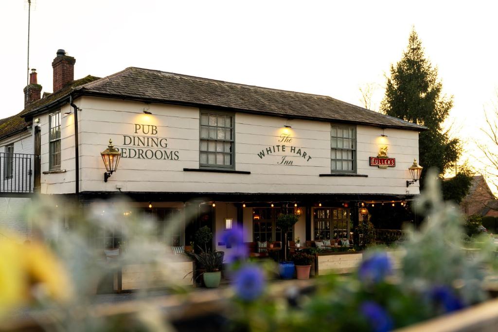 a white building with a sign on it at The White Hart in Stockbridge