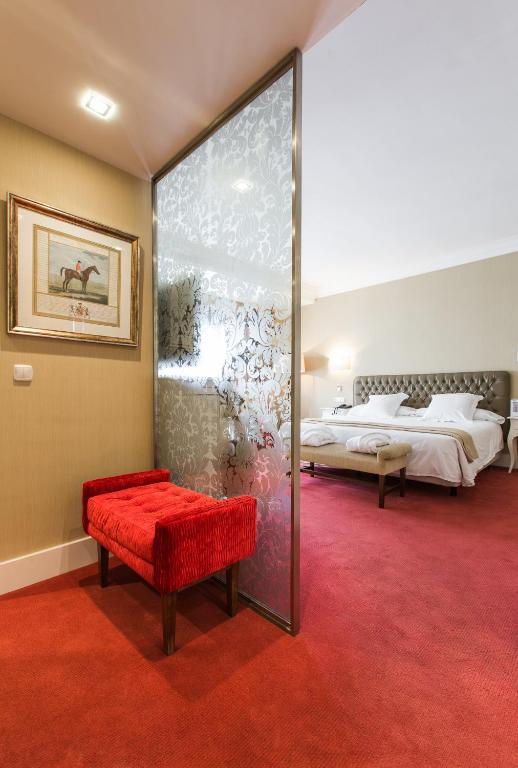 Postel nebo postele na pokoji v ubytování Hotel Carlton
