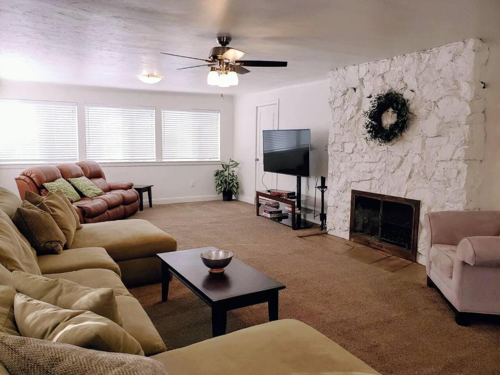 a living room with a couch and a fireplace at The Lindon House in Lindon