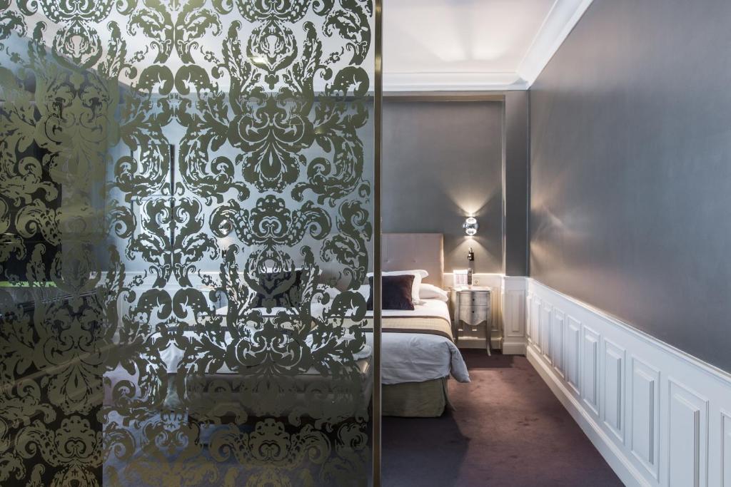 Postel nebo postele na pokoji v ubytování Hotel Carlton