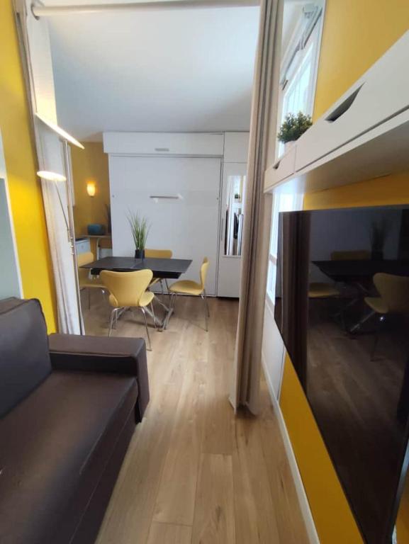 a living room with a couch and a table at Le 4 Saisons in Ustou