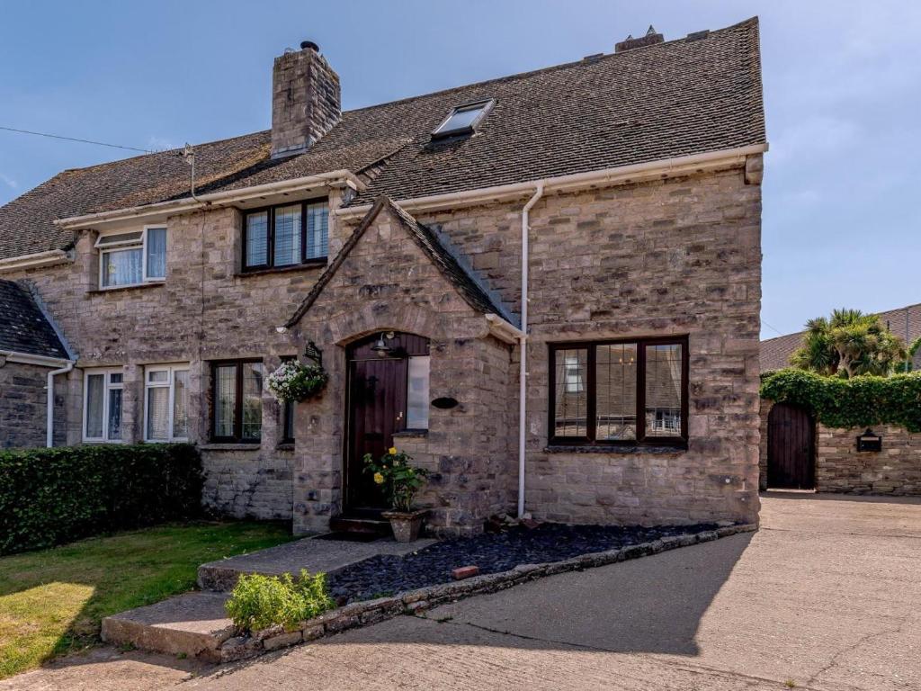 a large brick house with a driveway at 3 Bed in Wareham oc-78831 in Corfe Castle