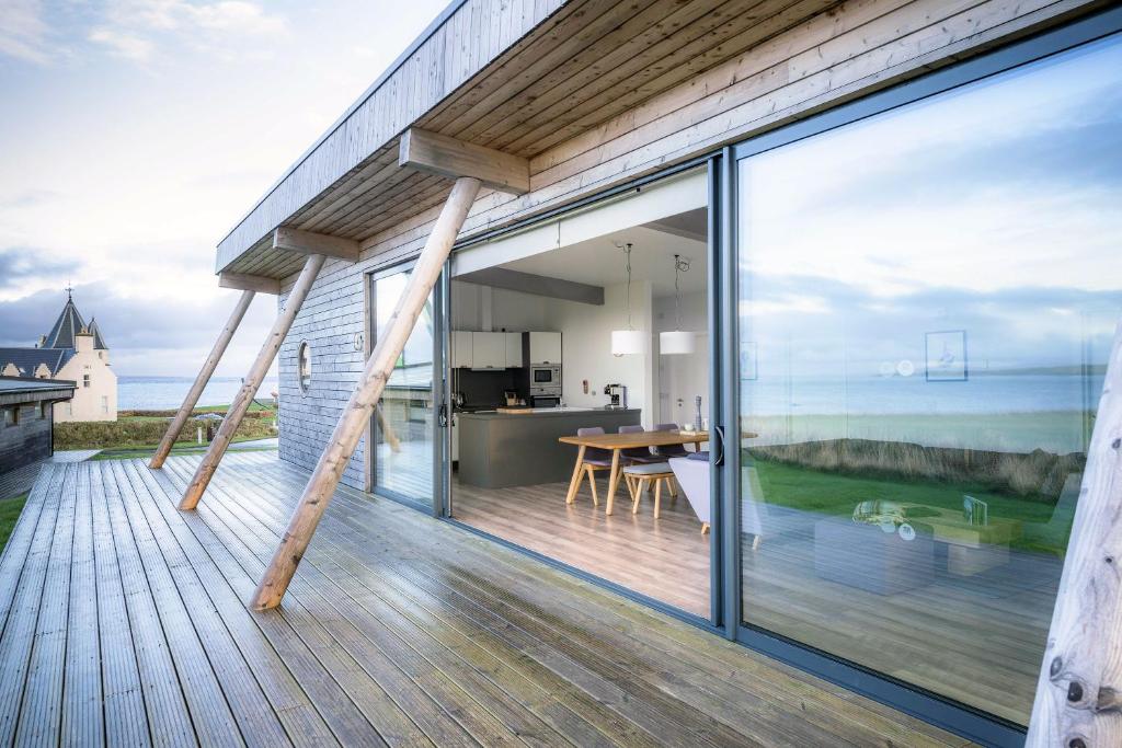 an open balcony with a view of the ocean at Jog Lodge 10 By Together Travel - 3 Bed in John O Groats