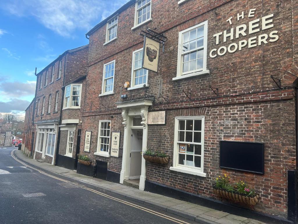 a brick building with the three cooperers sign on it at The Three Coopers in Bedale