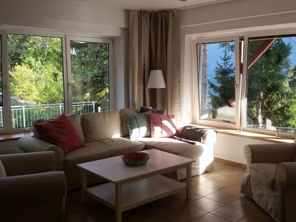 a living room with a couch and two windows at Apartment Jacob by Interhome in Dölsach