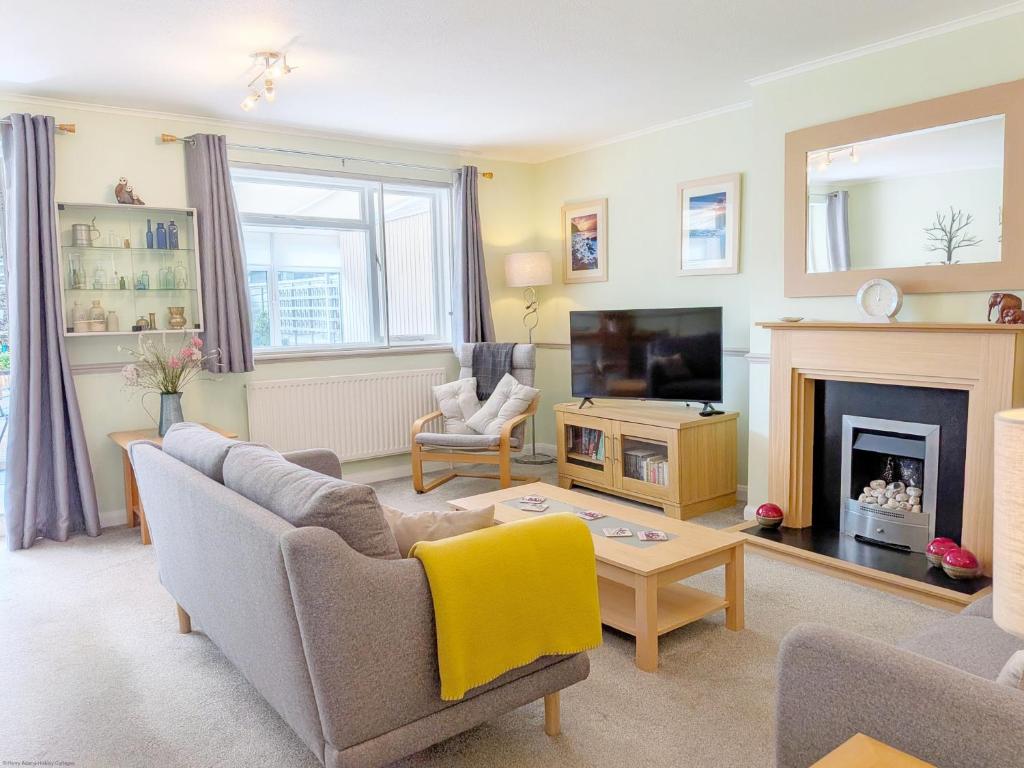 a living room with a couch and a fireplace at Orchard Mews , Barnham in Barnham