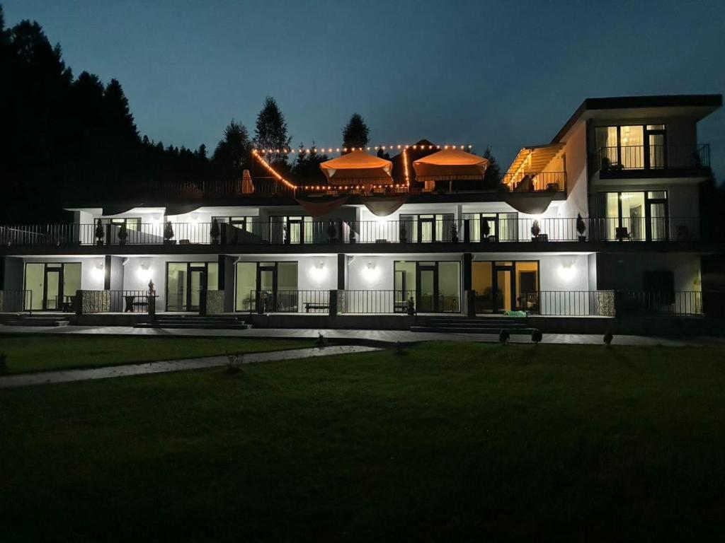 a large house at night with its lights on at Zveniv Resort in Oryavchyk