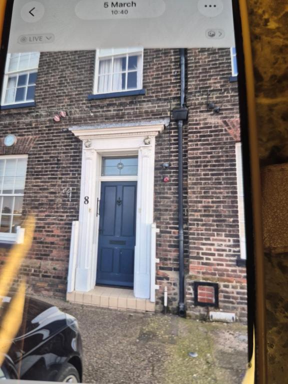a blue front door of a brick building at 8 River view in King's Lynn