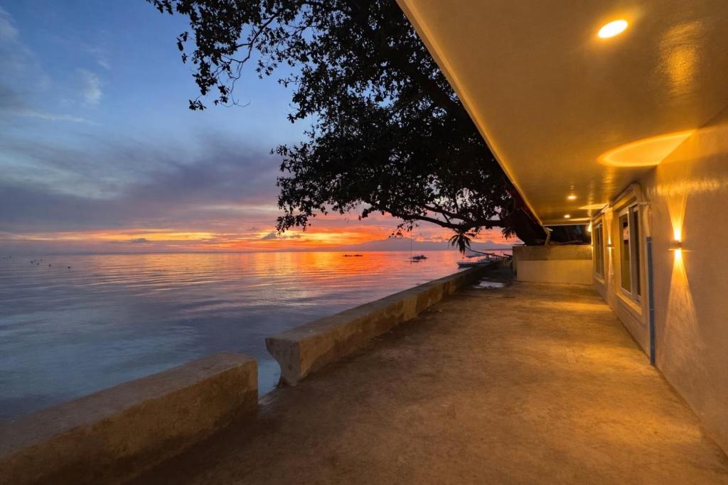 a building with a view of the ocean at sunset at Ellen Homestay in San Juan