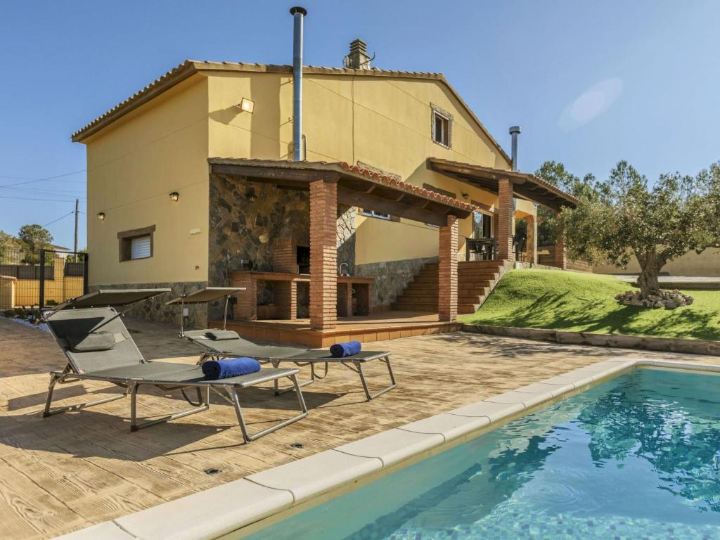 a villa with a swimming pool in front of a house at Villa Can Gordei by Interhome in Albinyana