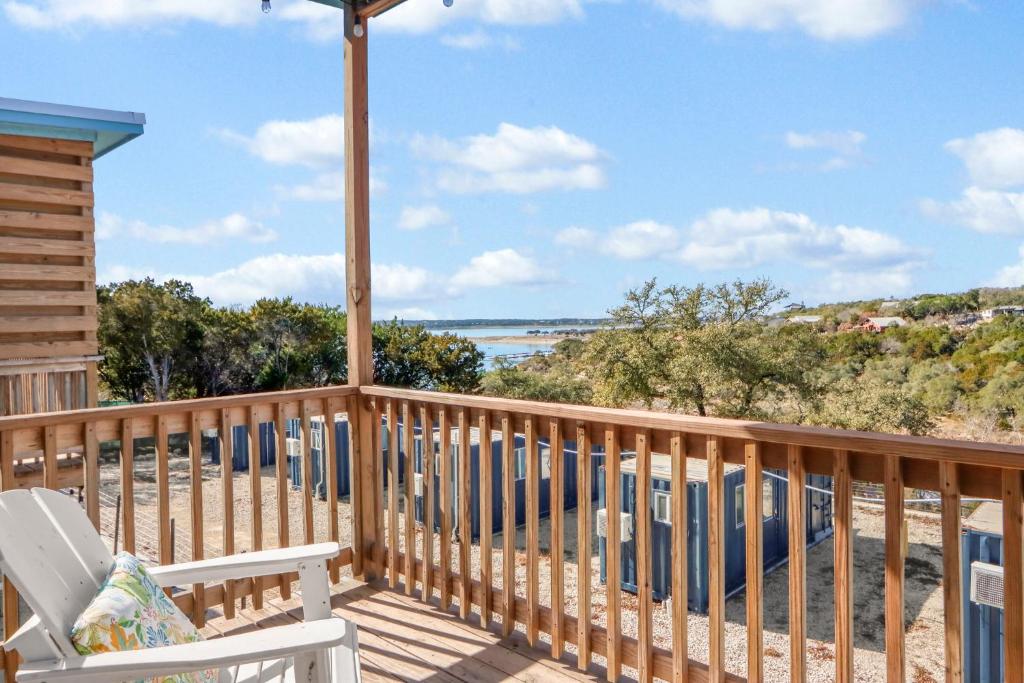 a deck with a chair and a view of the ocean at The Container Retreat - 3B in Canyon Lake