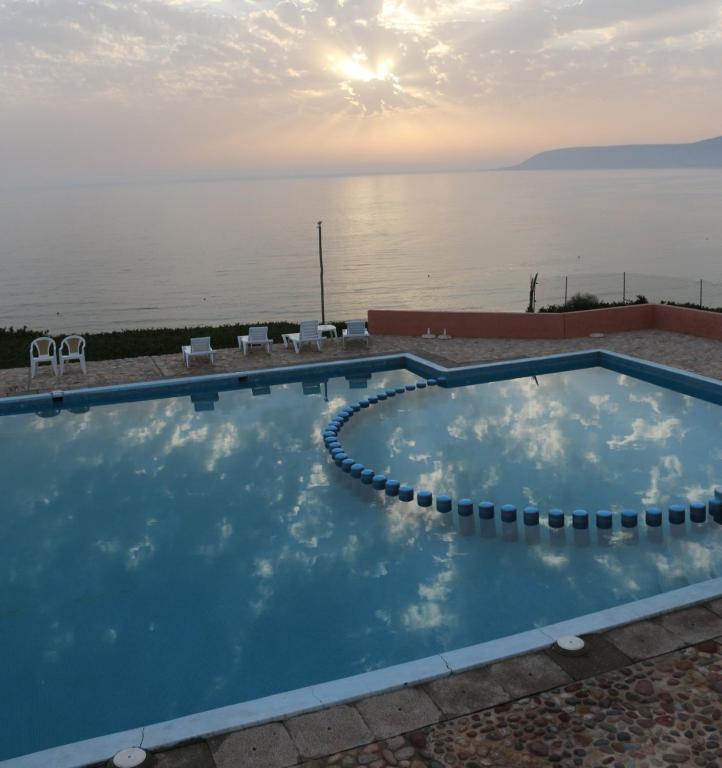 a swimming pool with a view of the water at Terre d'Océan in Taghazout