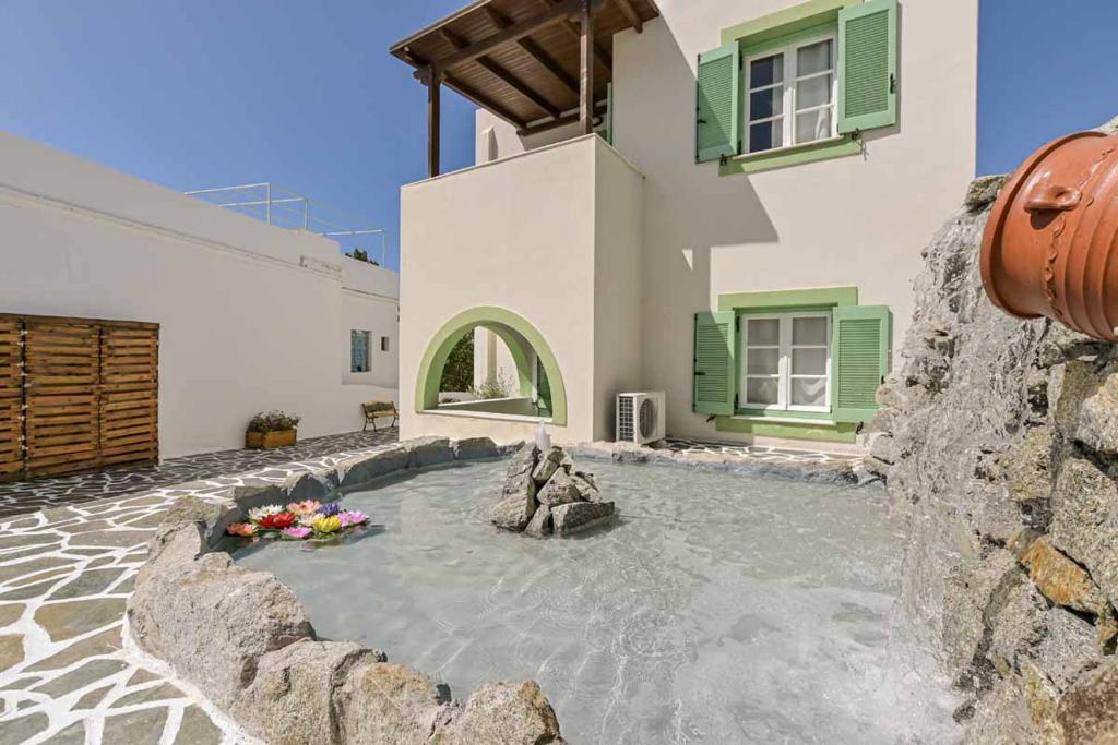 a house with a flower arrangement in front of it at Naxos olive & home in Engares