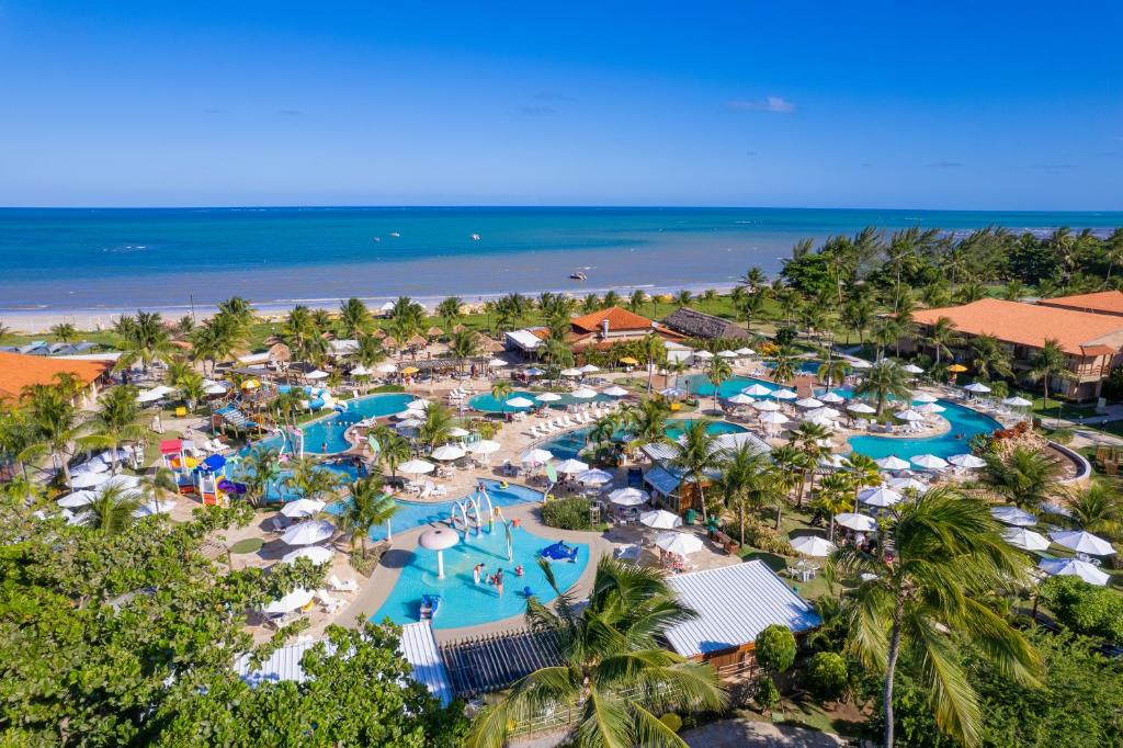 an aerial view of a resort with pools and umbrellas at Salinas Maragogi All Inclusive Resort in Maragogi