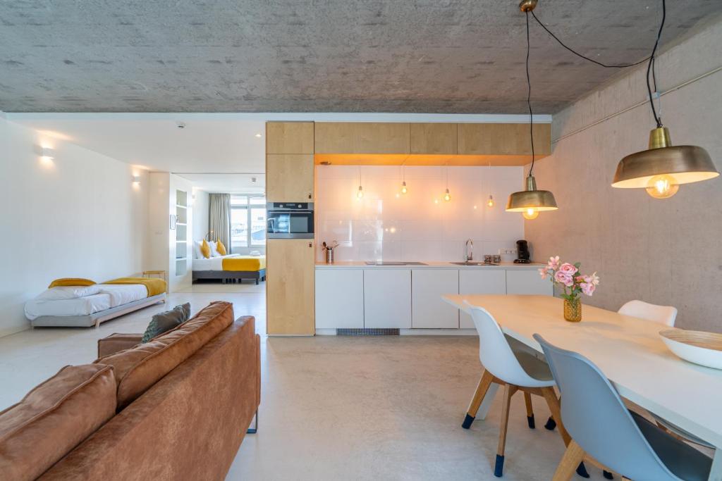 a living room and kitchen with a couch and a table at Houthaven Apartments in Amsterdam