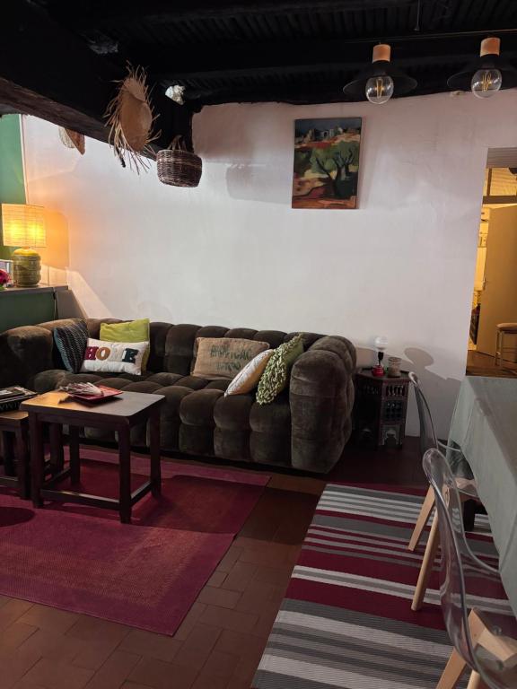 a living room with a couch and a table at Maison de village in Ortiporio