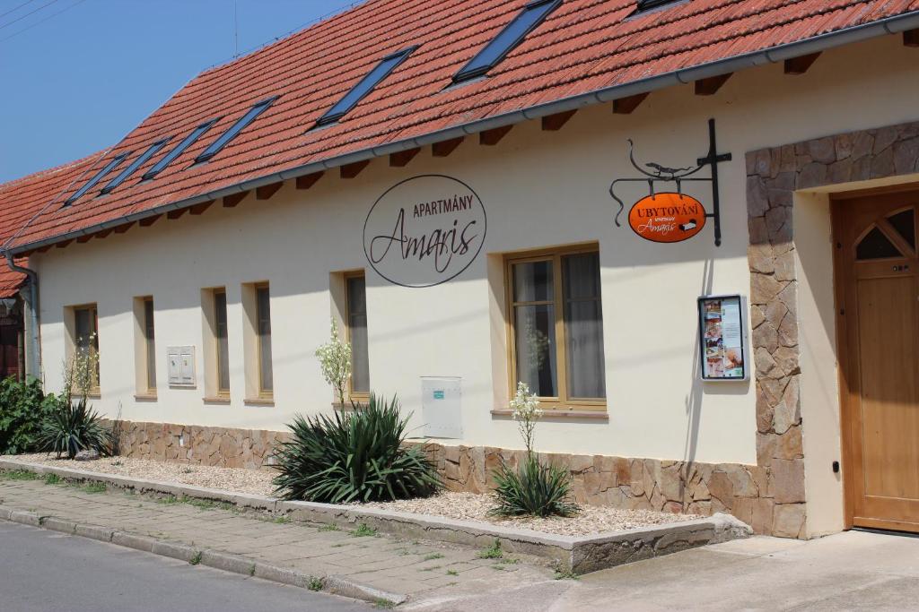 a building with a sign on the side of it at Apartmány Amaris in Strachotín