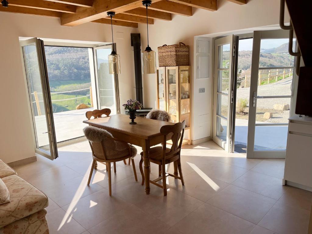a dining room with a table and chairs and a view at Casa Rural A Costa - Villa Rustica Asturias - Boal in Boal