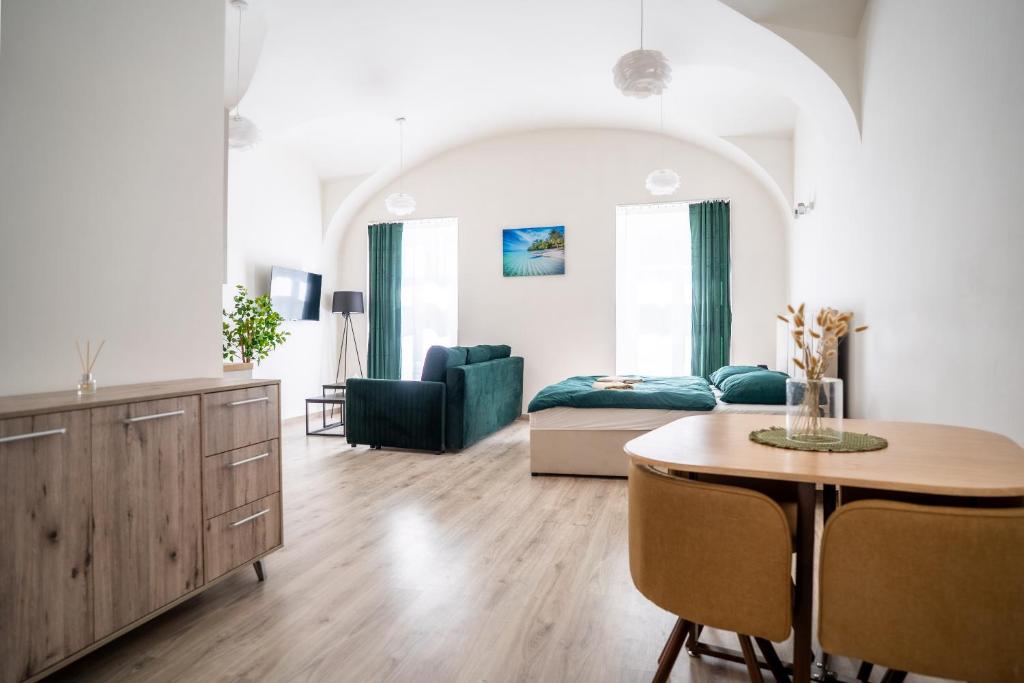 a living room with a table and a couch at Luxapart V Beautiful Views with Breakfast option in Košice