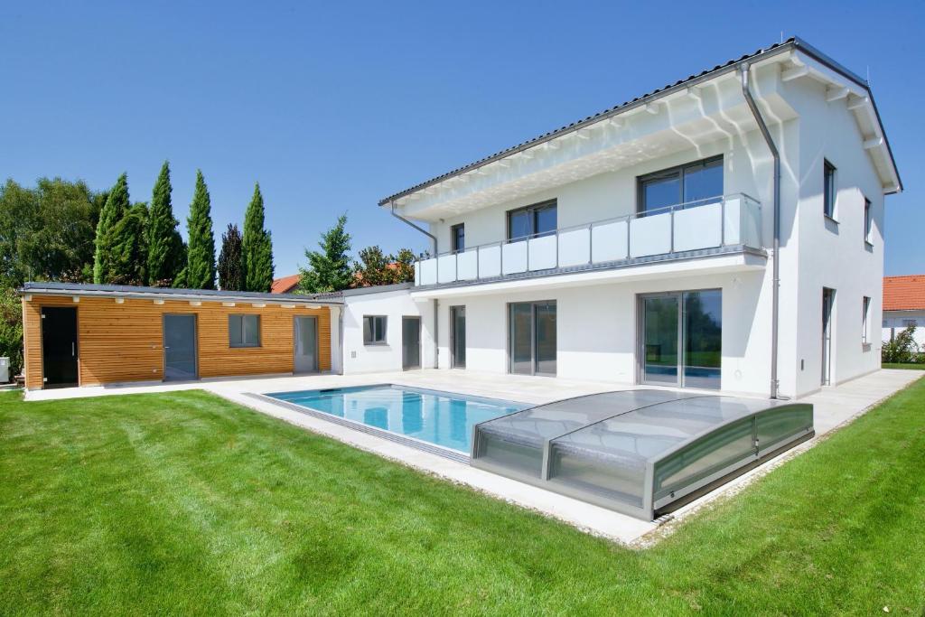 a house with a swimming pool in a yard at Villa 60, luxuriöse Villa mit Pool, Sauna und großem Garten in Gols