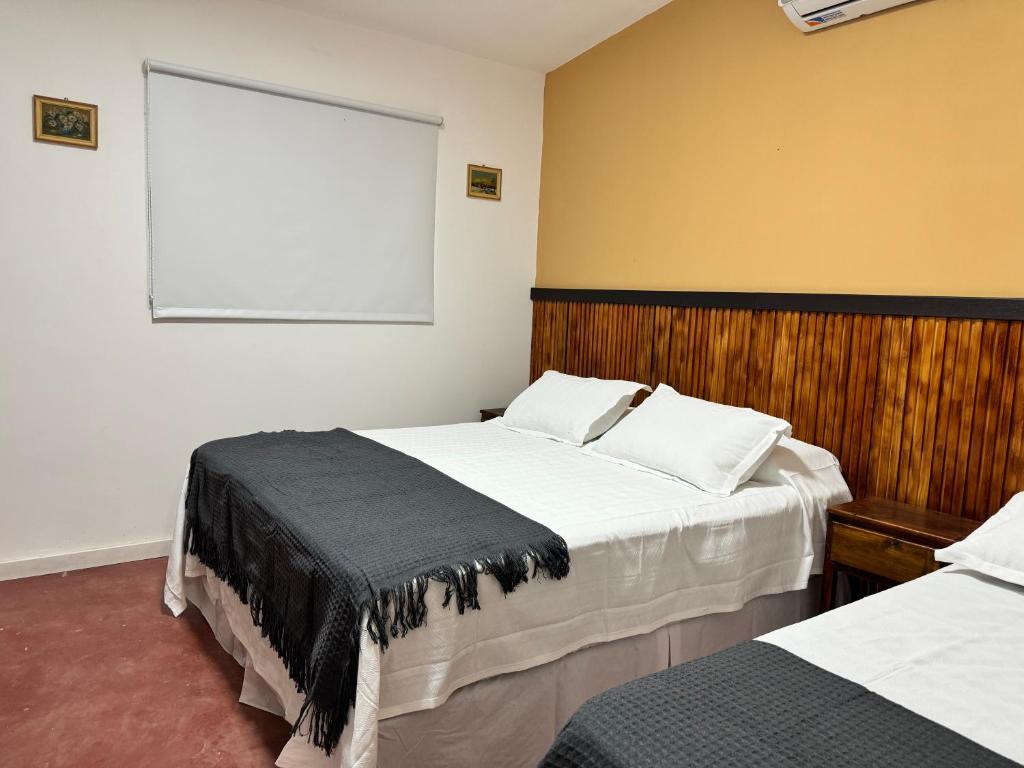 a bedroom with two beds and a large window at Complejo La Mística in Copacabana