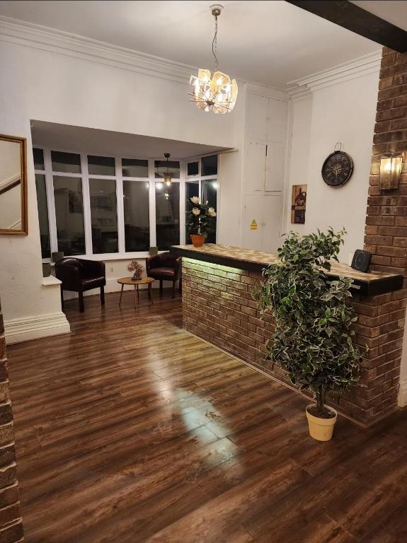 a living room with a brick wall and a bar at The Limes Hotel in Market Rasen