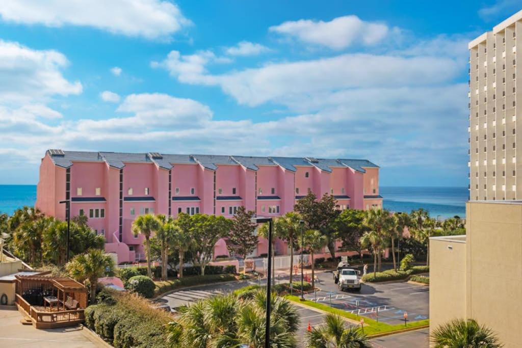 a pink building with the ocean in the background at TOPS'L Tides in Destin