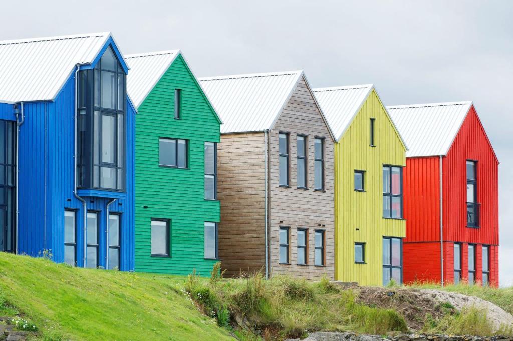 a row of colorful houses on a hill at Findochty - 2 Bed Luxury Apartment by Together Travel in Wick