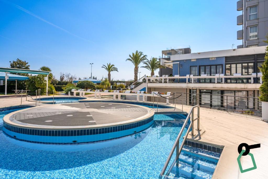 a view of two swimming pools in a building at Hotiday Chioggia Lungomare in Sottomarina