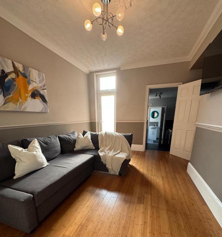 a living room with a couch and a chandelier at Spacious 2 BR Flat in Gateshead - Free Parking in Gateshead