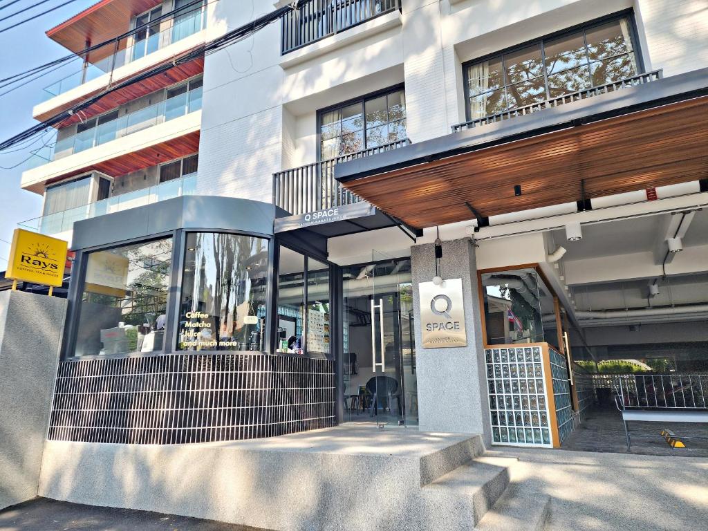 a store front of a building with glass doors at Q Space Sathorn - Narathiwas 18 in Ban Nong Chaeng